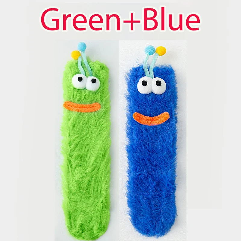 Funny monster fleece winter socks in green and blue, featuring playful designs and soft textures for cozy warmth.