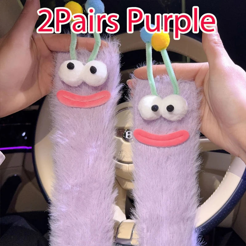 Funny monster fleece winter socks in purple with cute faces and colorful antennas, perfect for cozy lounging.