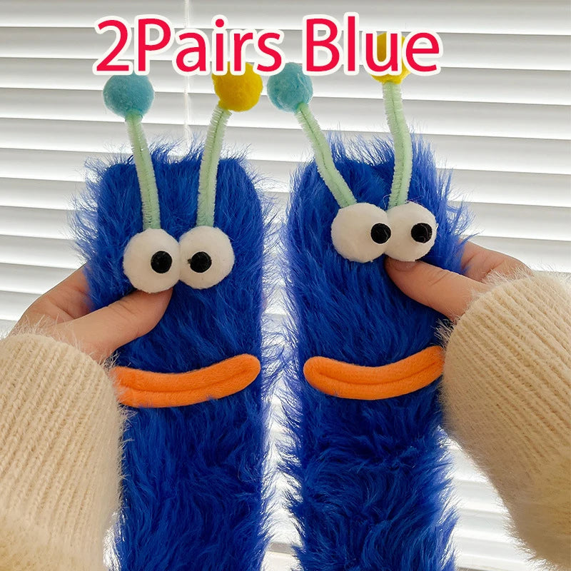 Funny monster fleece winter socks with blue color, featuring cute eyes and antennae, providing cozy warmth and fun style.