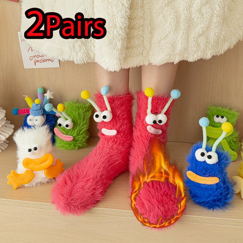 Funny monster fleece winter socks on feet, surrounded by colorful plush monster toys, showcasing cozy and playful design.