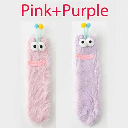 Funny monster fleece winter socks in pink and purple with cute eyes and antennae.