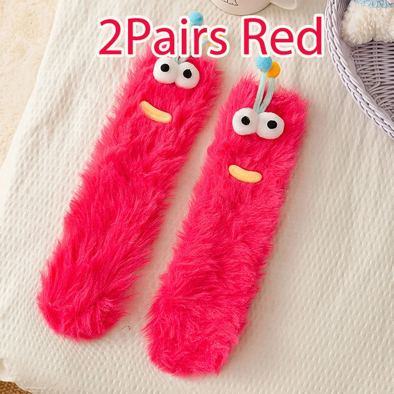 Funny monster fleece winter socks in red color with cute eyes, perfect for keeping warm and cozy.